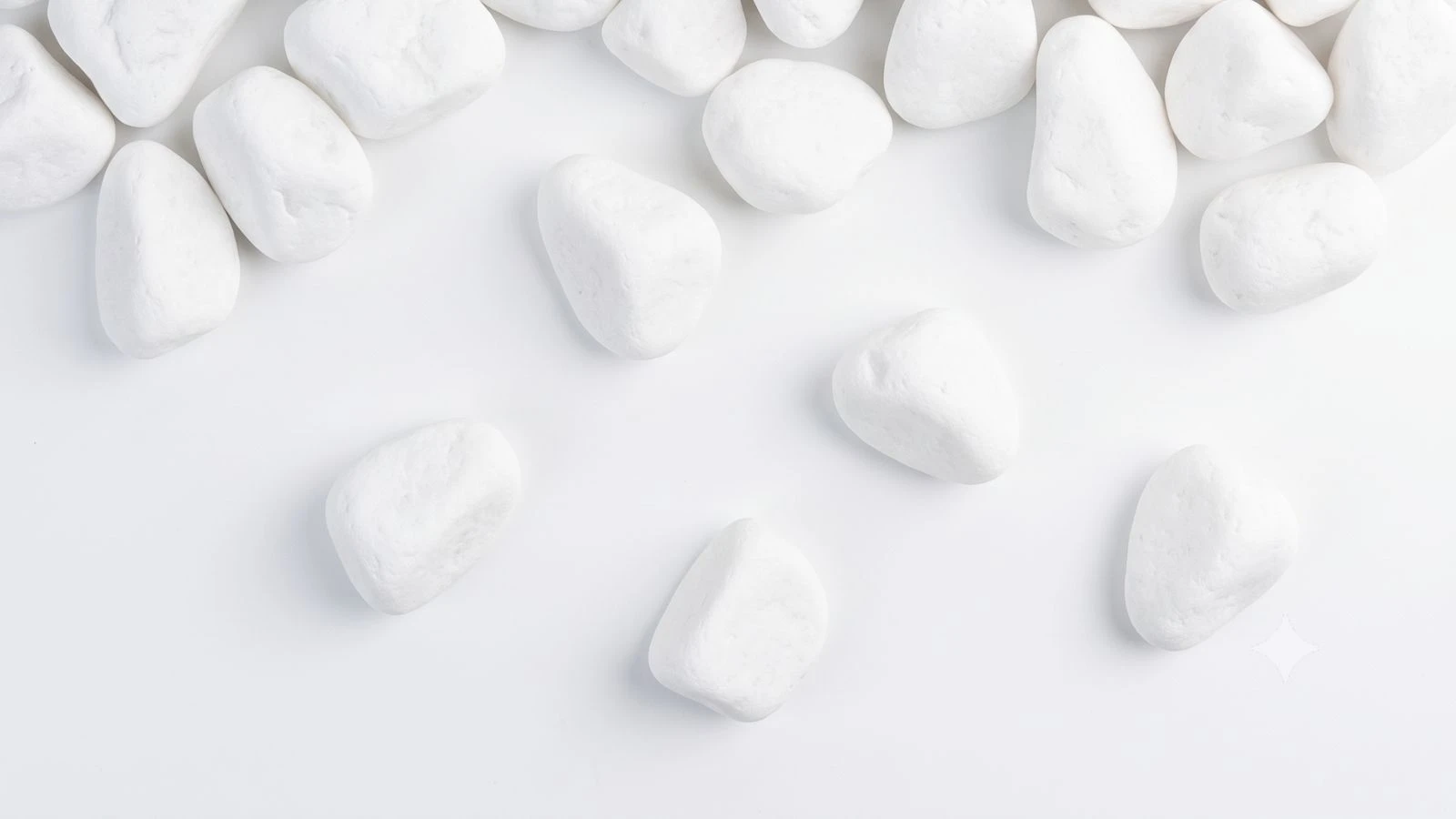Snow-White Thassos marble pebbles in a UK garden — pure bright white decorative stones used across a finished border